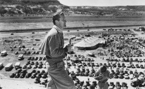 Black and white photo of man in fatigues looking across horizon