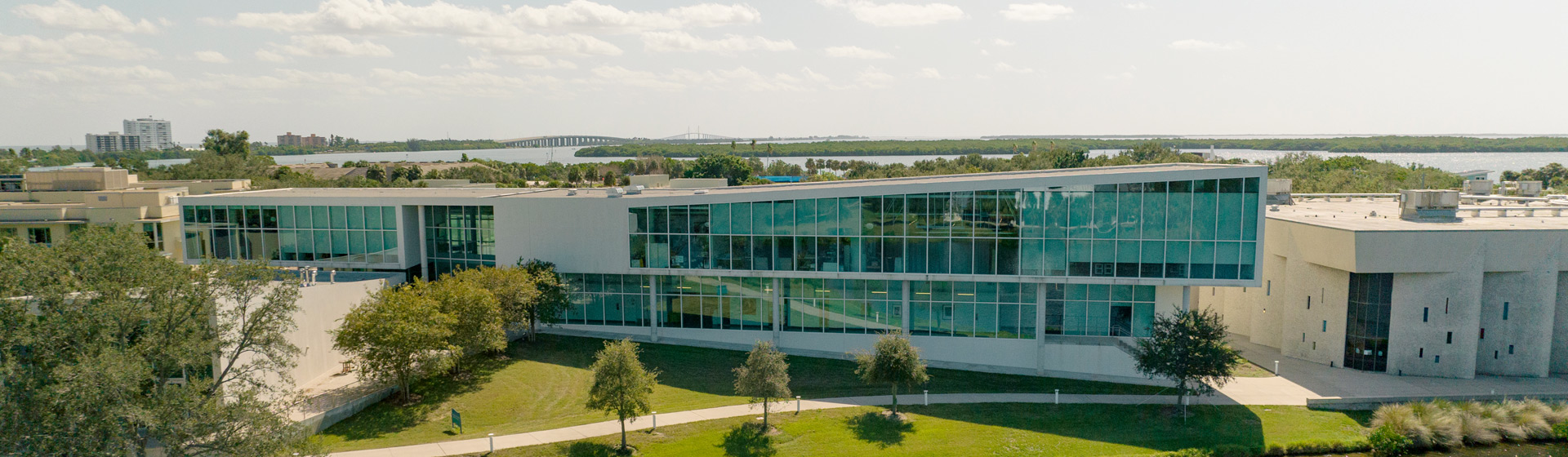 Aerial view of modern building with bay in background