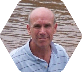 Larry Greenwood in a boat on a river