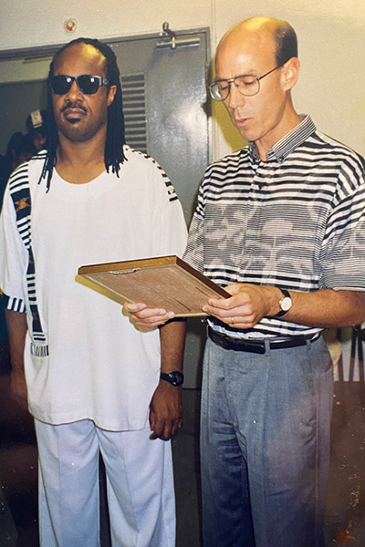 Greenwood giving Stevie Wonder an award in Singapore in 1993