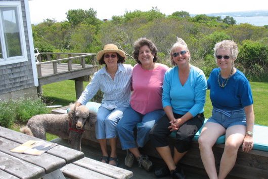 Four ladies seated on outdoor deck