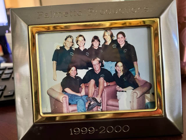 A framed photo of Lova with seven other students