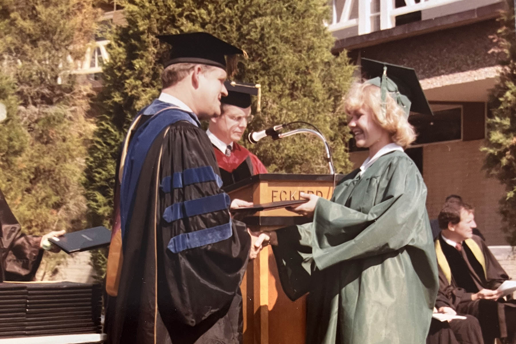 Female graduate receiving her degree on stage
