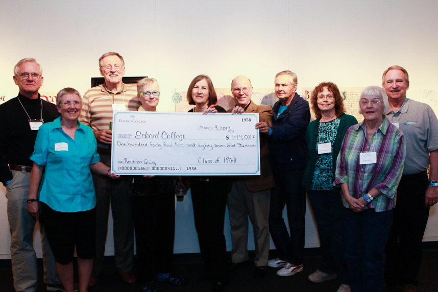 Group of people holding up an oversized check