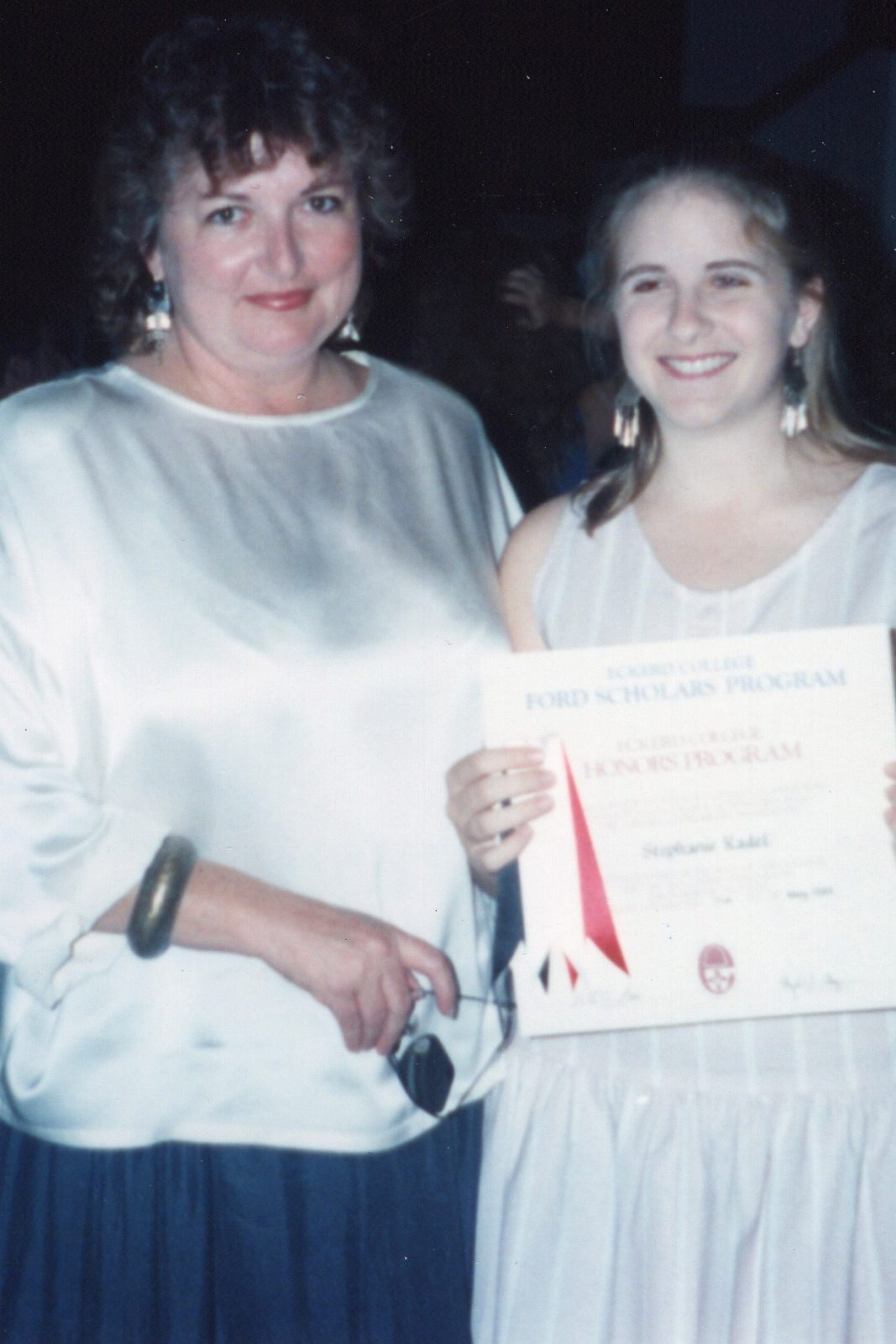 College student holds certificate alongside her mentor