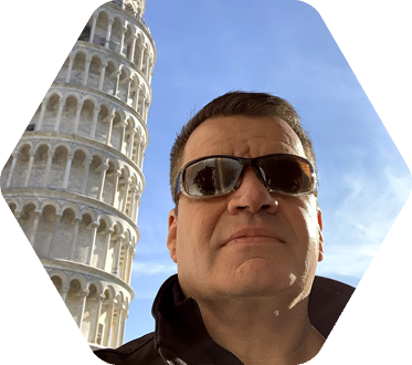 Closeup of man in sunglasses with the leaning tower of Pisa in background