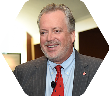 Photo of a smiling man in a suit and tie