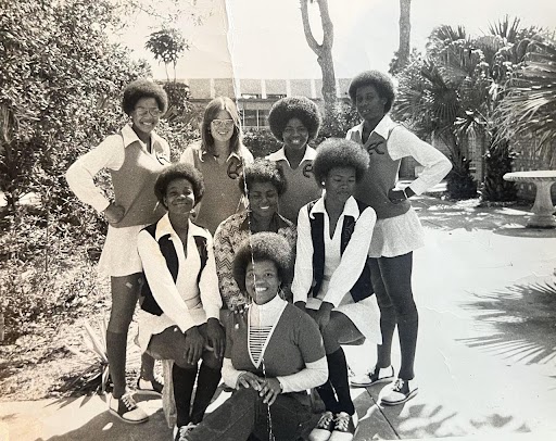 Black and white photo of eight young women posing on campus