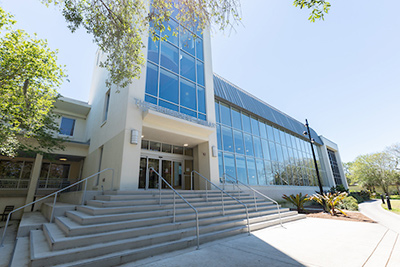 Exterior view of a library with steps going up to main entrance