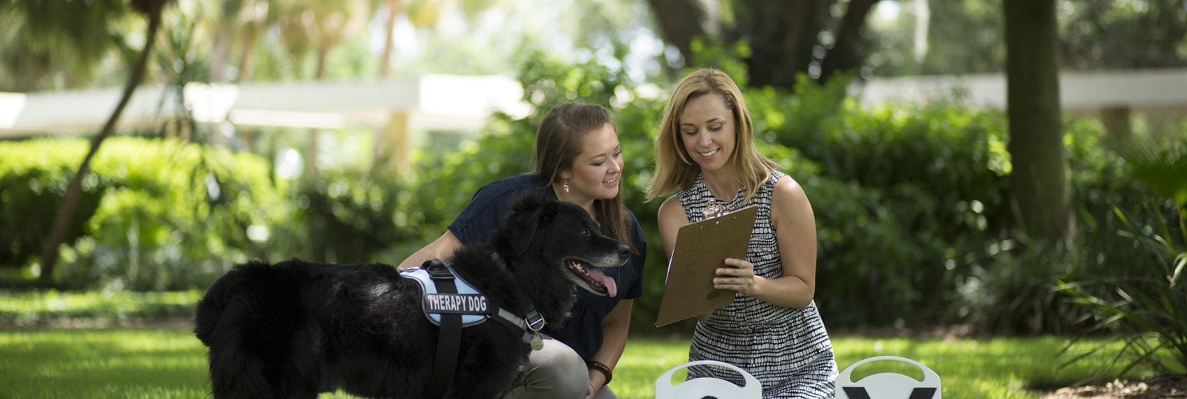 Animal Studies student with professor and dog