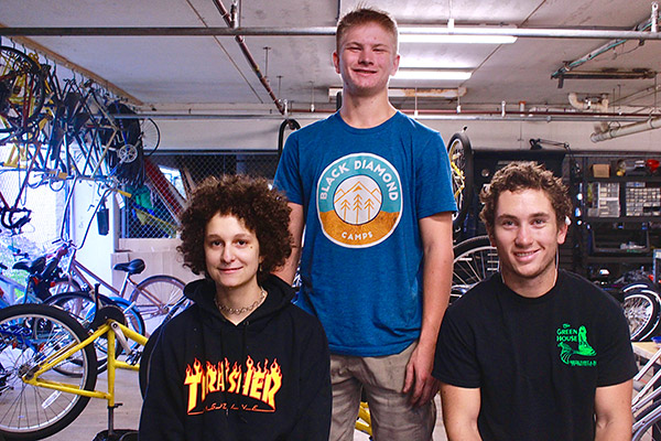 Three students in a bike shoip