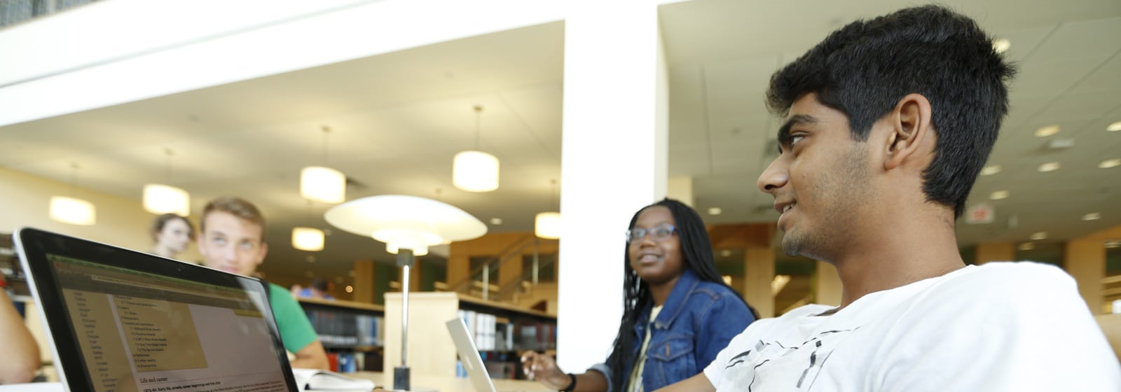 Student in library with laptop