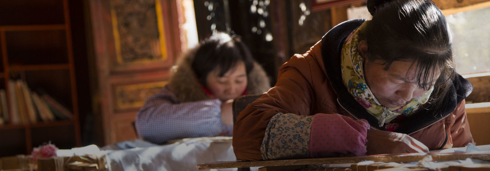 Two women in Lijiang embroidering silk, taken by Lia Nydes '15 on a Winter Term trip to China
