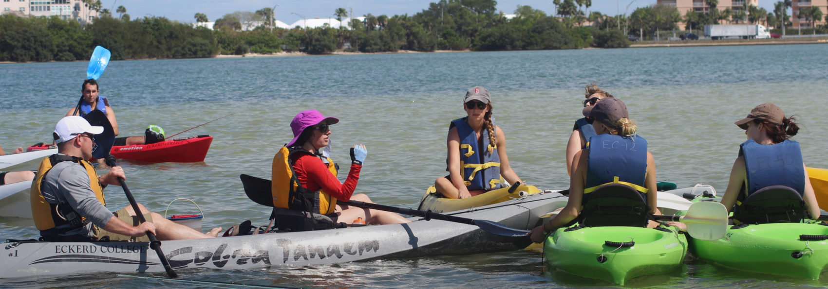 Professor Boucquey teaches students on kayaks