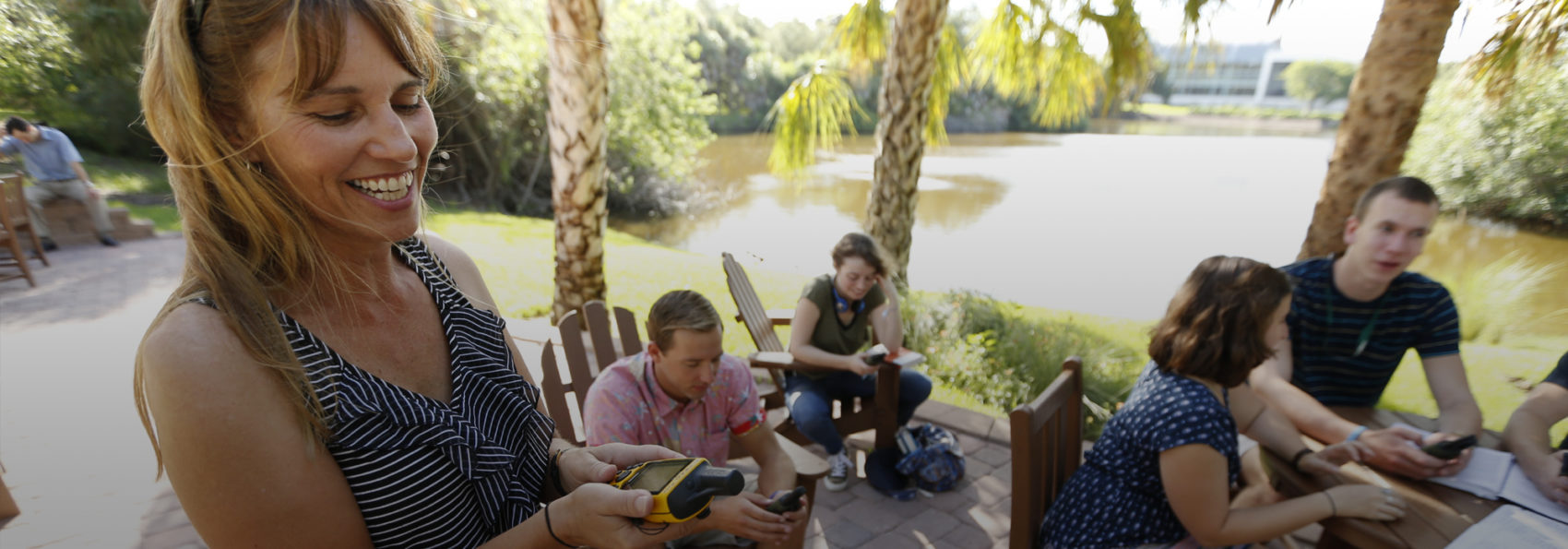Beth Forys, Professor of Environmental Science & Biology, teaches a class to students outside around Fox Pond.