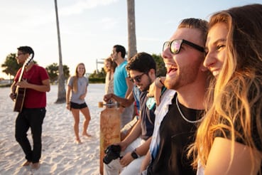Students laughing on the beach
