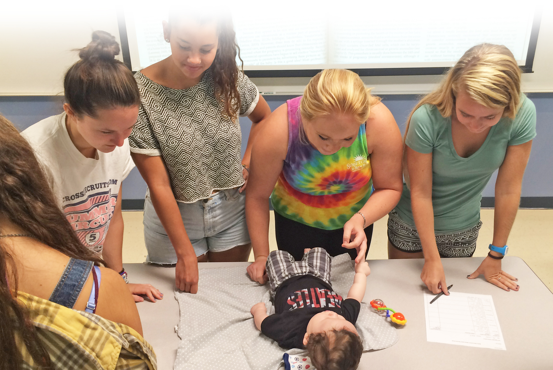 Students studying infant reflexes in Introduction to Human Development