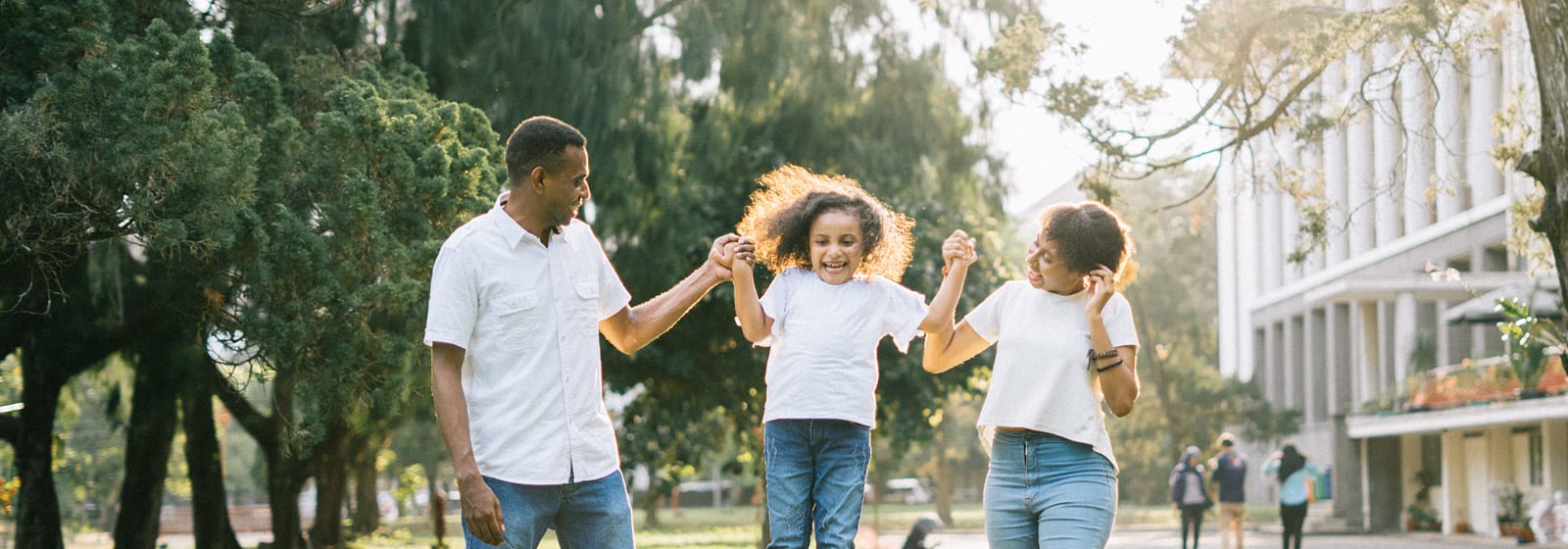 Parents swinging their child in the air