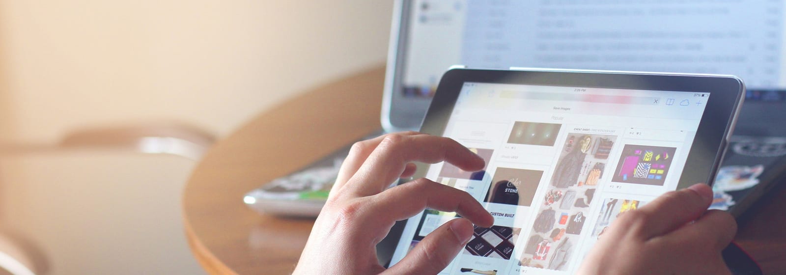 Hands holding an ipad showing products for sale