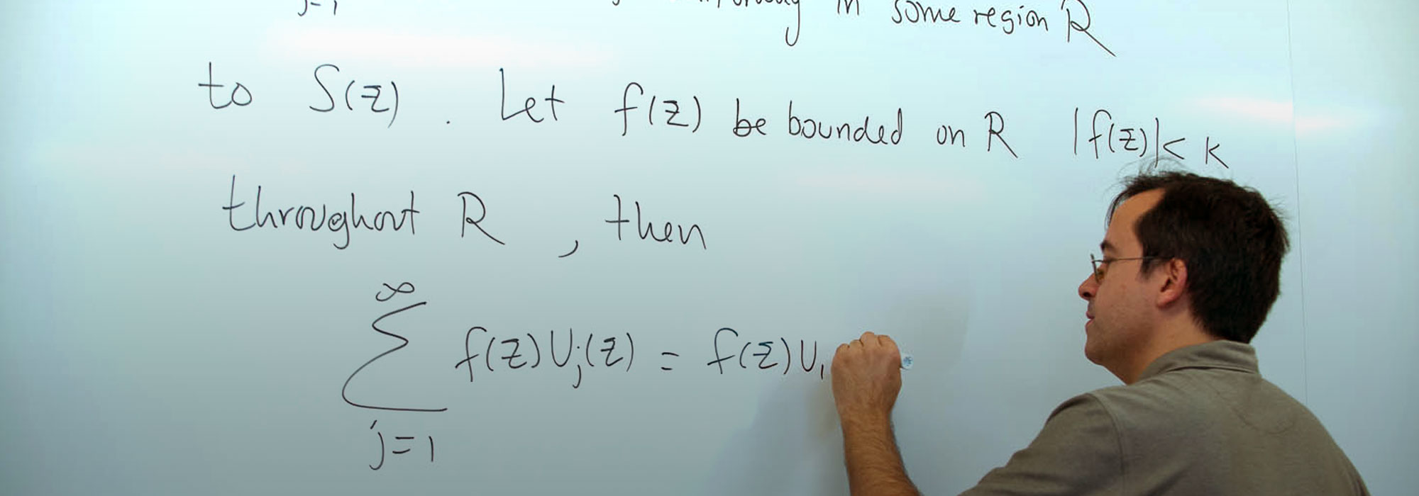 Professor Fernandez writing an equation on a white board
