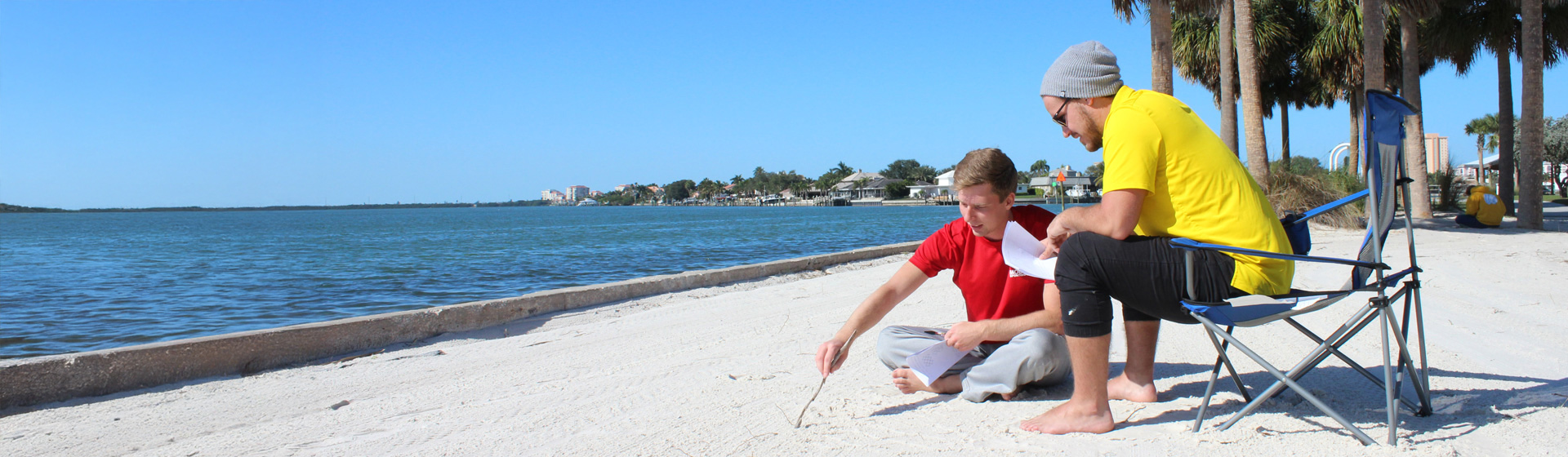 Students studying graph theory in the sand