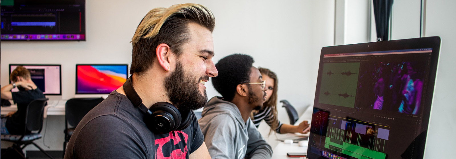 Eckerd music student edits audio on a computer