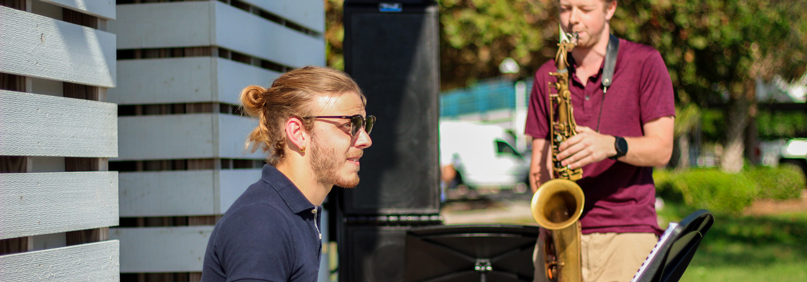 Eckerd College music majors playing jazz keyboard and saxophone outside