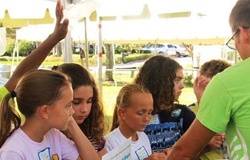 Eckerd students talking to kids at the annual St. Pete Science Festival