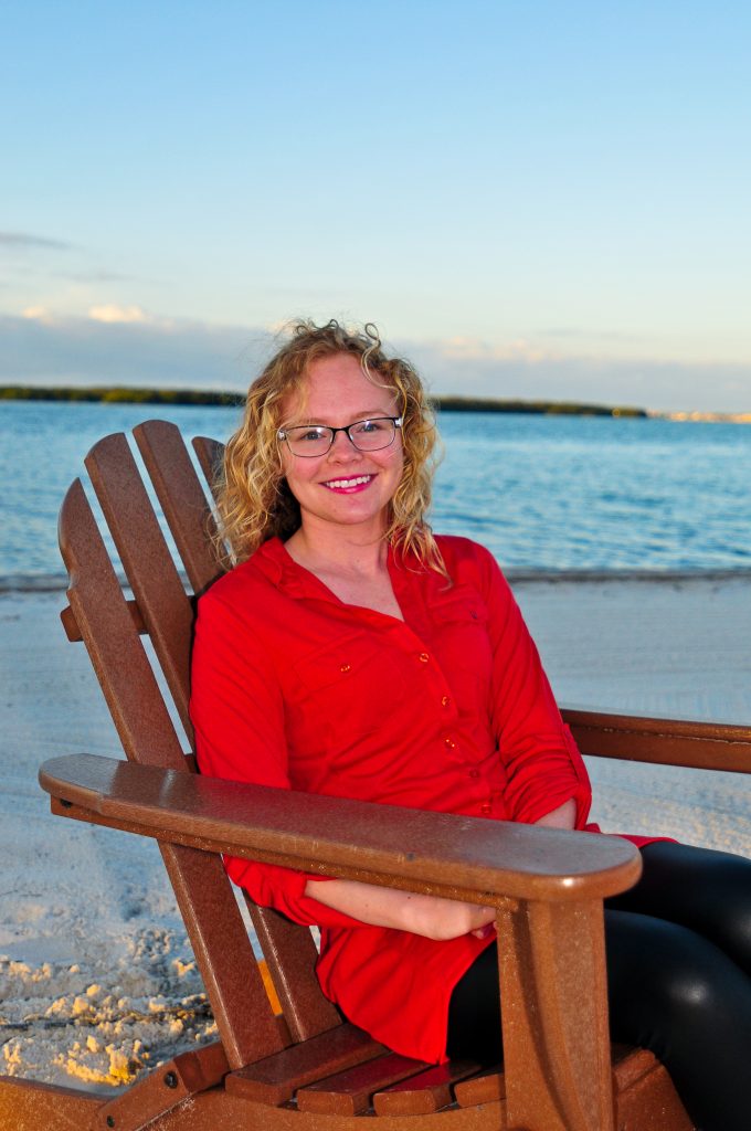 Brittany N. Evans sits in a chair on Eckerd College's South Beach.