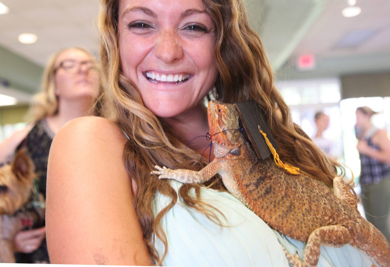 Danielle Becker poses with her pet bearded dragon at pet commencement 2016.