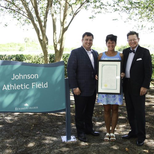 Ian and Maureen Johnson stand with Presdient Eastman on the new Johnson Field.