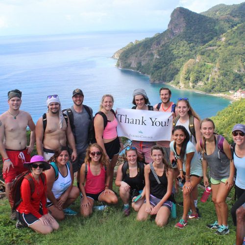 Students pose on edge of cliff