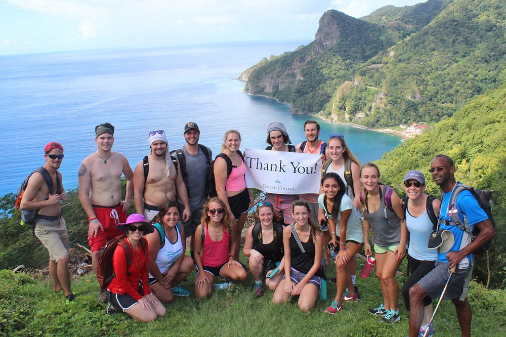 Students pose on edge of cliff
