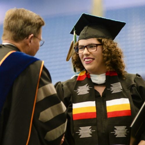 Lina Longtoe Schulmeisters ’18 shaking hands with President Eastman at Commencement