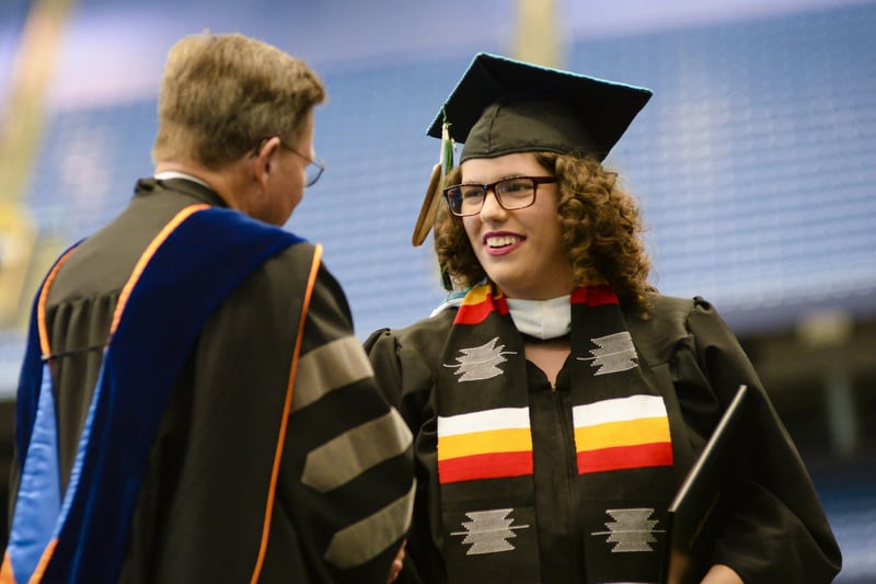Lina Longtoe Schulmeisters ’18 shaking hands with President Eastman at Commencement