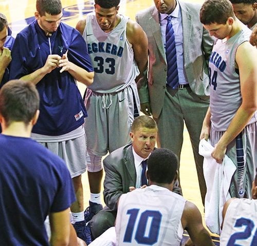 Coach Ryan in the huddle with his team