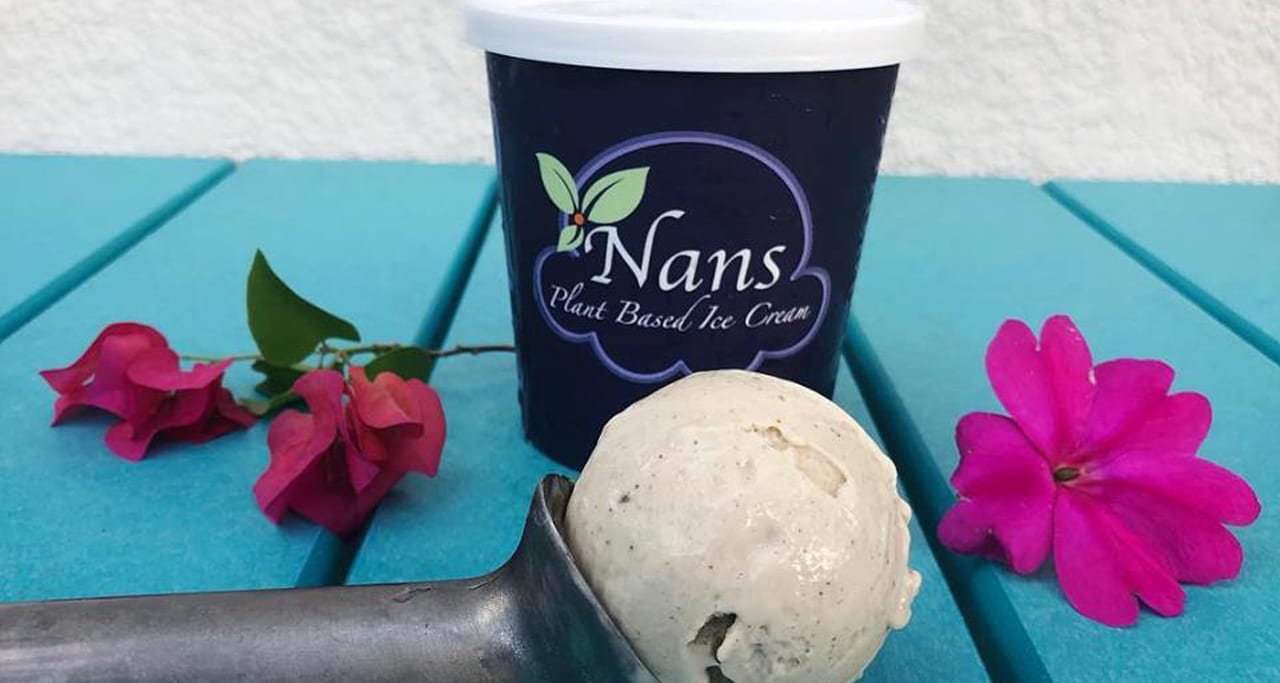 Scoop of ice cream in front of cup with Nans logo