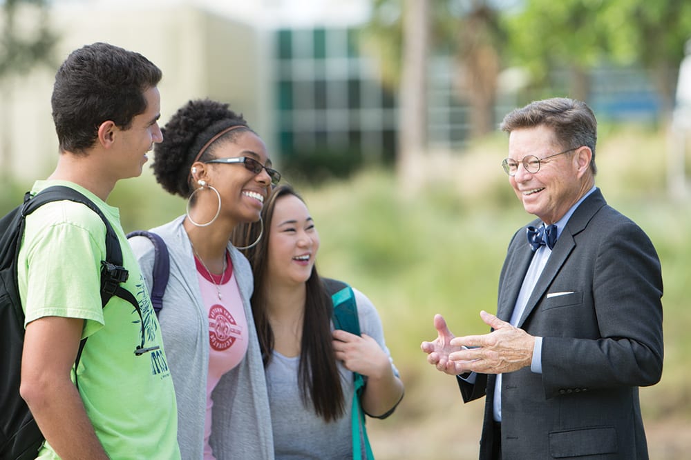 Dr. Eastman laughing with students
