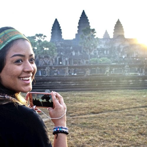 Student with camera at ruins in far east