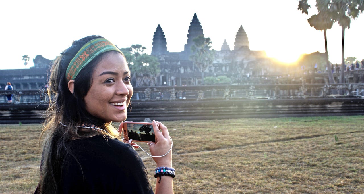 Student with camera at ruins in far east