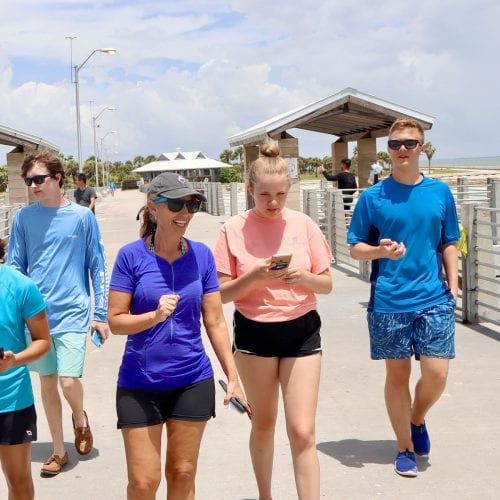 Professor Forys with students, walking along pier