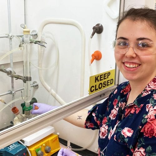 Eckerd chemistry student wearing goggles in lab