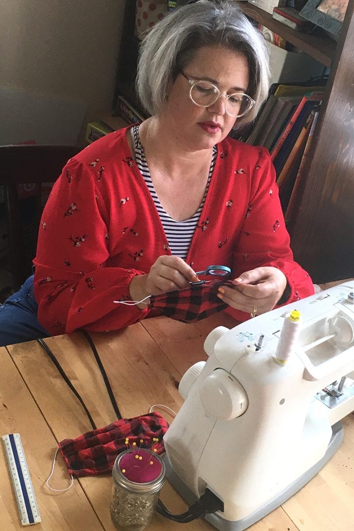 Eckerd College Theatre Professor Jessica Thonen sewing a mask