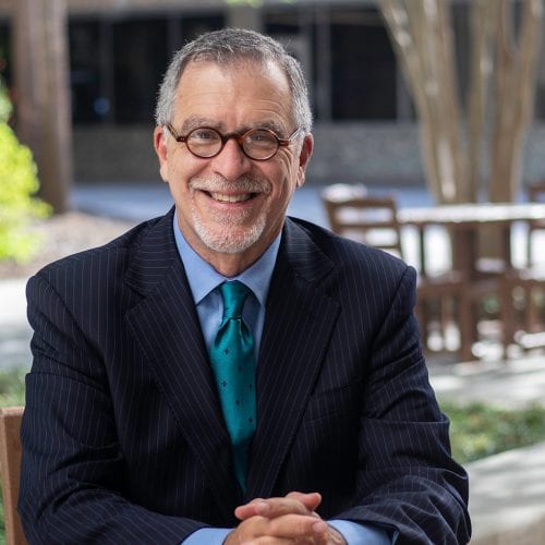 Dr. Fernández sits at an outdoor table