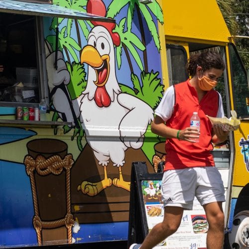 Eckerd student walks away from food truck on campus