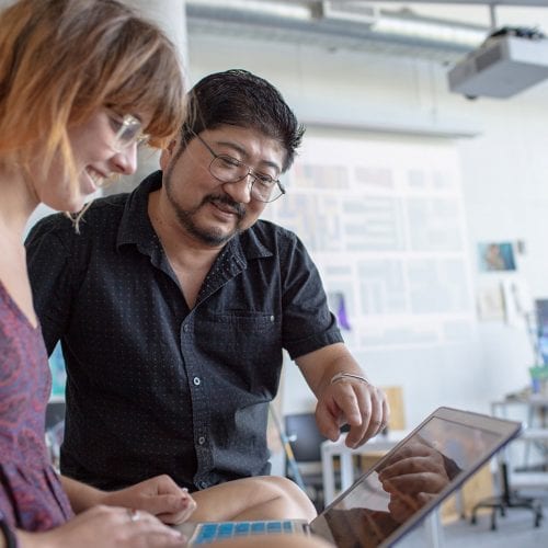 Visual Arts professor Kirk Wang teaching painting to Eckerd student Zoe Turtle '18