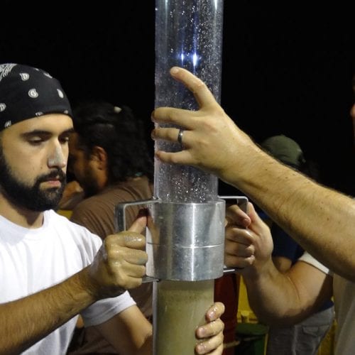 Bryan O'Malley (left) and Patrick Schwing (right) transfer a seafloor sediment core for storage aboard the B/O Justo Sierra, operated by the National Autonomous University of Mexico (photo credit: Devon Firesinger)