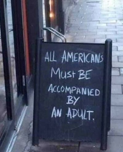 All Americans must be accompanied by an adult - sandwich board outside a pub in London