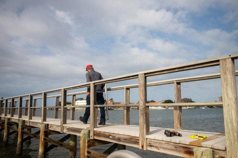 Staff installing wires under Galbraith pier