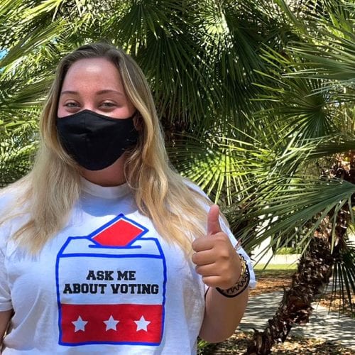 Student wearing "Ask me about voting" shirt